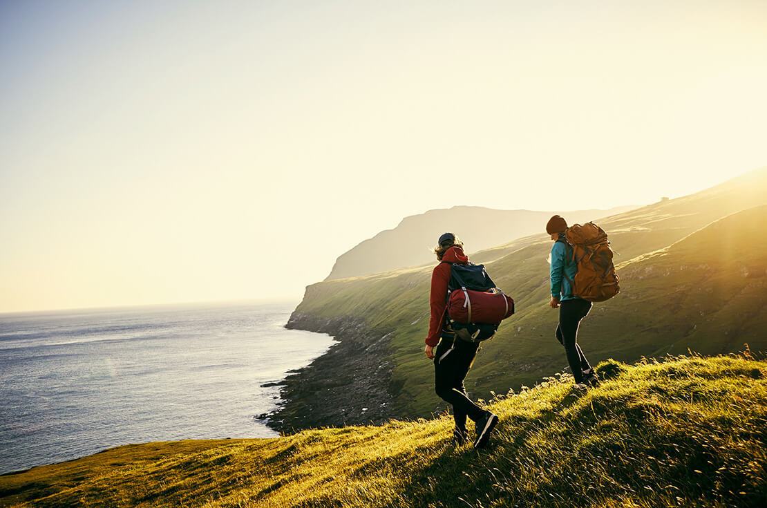 Shot of a young couple hiking through the mountains